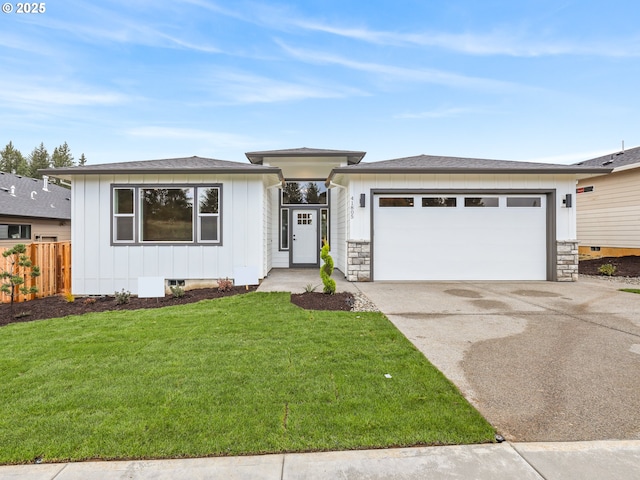 2891 NE Currin Creek Dr, Estacada, OR 97023 - prairie-style house featuring an attached garage, fence, board and batten siding, a front yard, and driveway