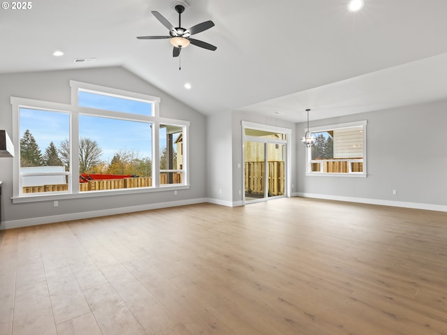 2891 NE Currin Creek Dr, Estacada, OR 97023 - unfurnished living room featuring wood finished floors, visible vents, lofted ceiling, and ceiling fan with notable chandelier