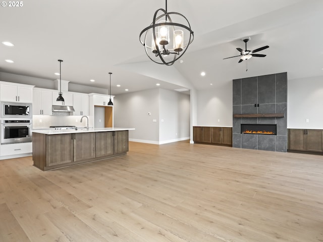 2891 NE Currin Creek Dr, Estacada, OR 97023 - kitchen featuring stainless steel appliances, recessed lighting, light wood finished floors, open floor plan, and white cabinets