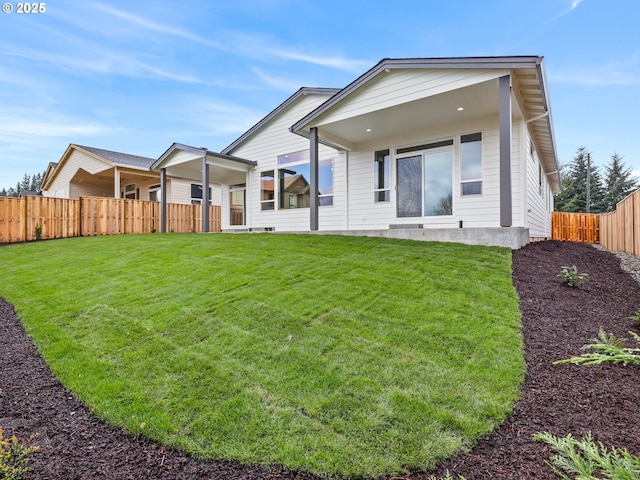 2891 NE Currin Creek Dr, Estacada, OR 97023 - rear view of house with a lawn and a fenced backyard