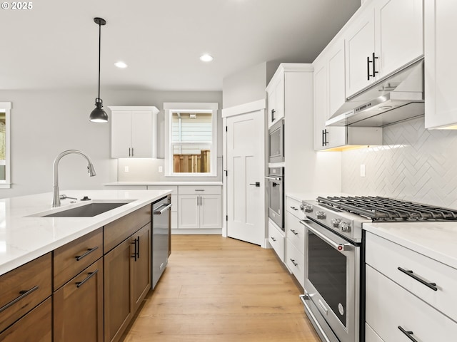 2891 NE Currin Creek Dr, Estacada, OR 97023 - kitchen featuring white cabinetry, a sink, appliances with stainless steel finishes, and under cabinet range hood