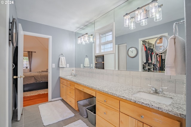 bathroom with vanity, tasteful backsplash, and tile patterned flooring