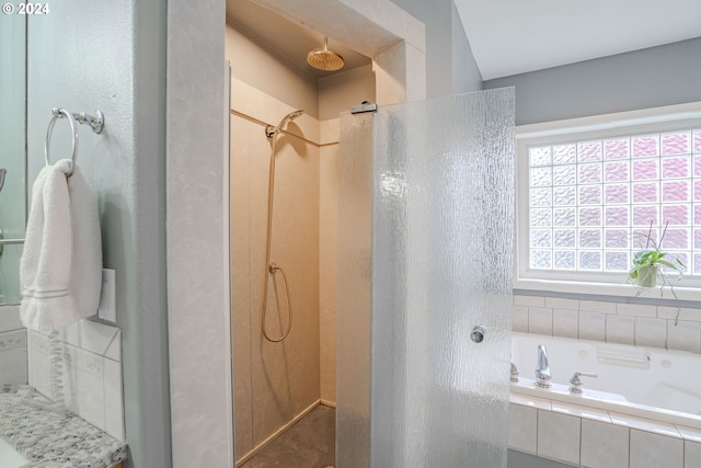 bathroom featuring shower with separate bathtub