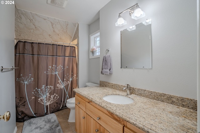 bathroom with vanity, toilet, tile patterned floors, and walk in shower