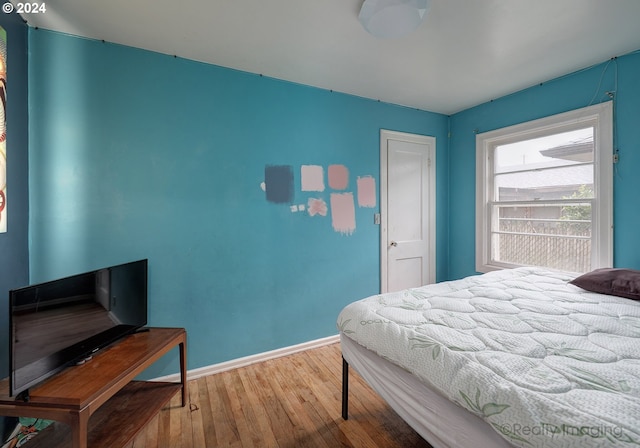 bedroom with hardwood / wood-style flooring