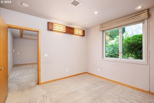 unfurnished room featuring light colored carpet