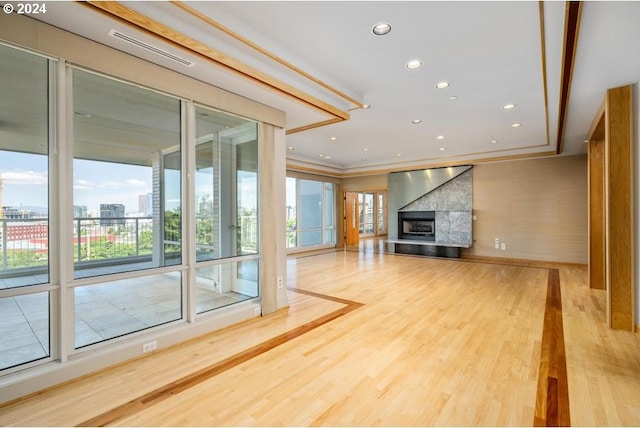 unfurnished living room featuring crown molding and hardwood / wood-style flooring