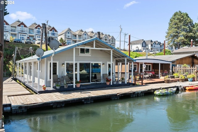 back of property with a deck with water view