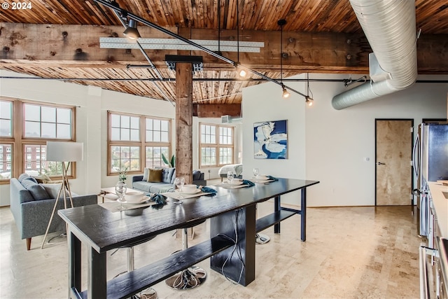 dining room featuring wooden ceiling and vaulted ceiling