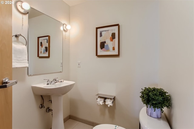 bathroom featuring tile floors and toilet