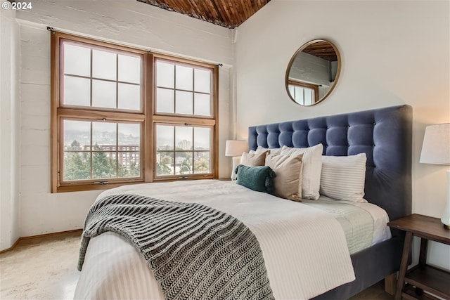 bedroom featuring wooden ceiling and concrete flooring