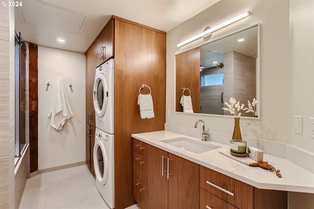 laundry room with stacked washer and clothes dryer, sink, and light tile flooring