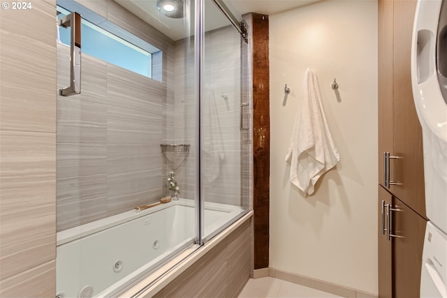 bathroom featuring tile floors and bath / shower combo with glass door