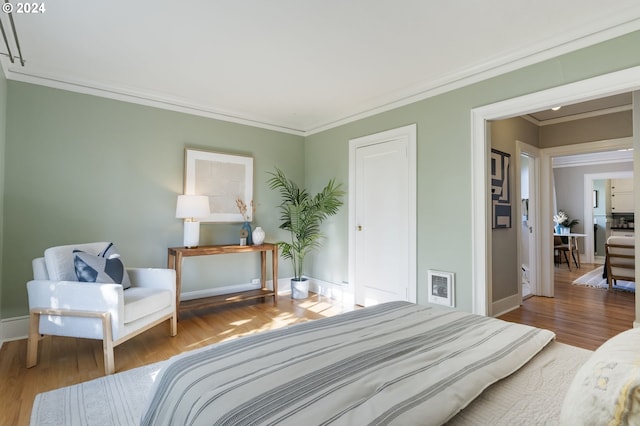 bedroom featuring wood-type flooring and ornamental molding