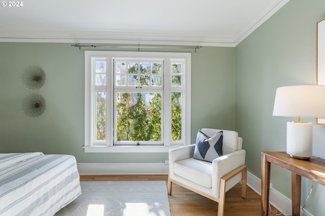 bedroom with crown molding and hardwood / wood-style floors