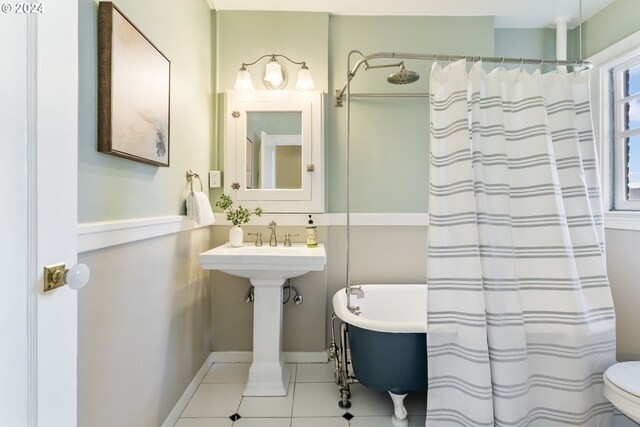 bathroom featuring toilet, tile patterned floors, and separate shower and tub