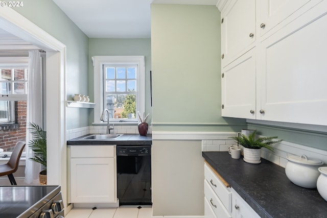 kitchen with a wealth of natural light, black dishwasher, sink, and white cabinetry