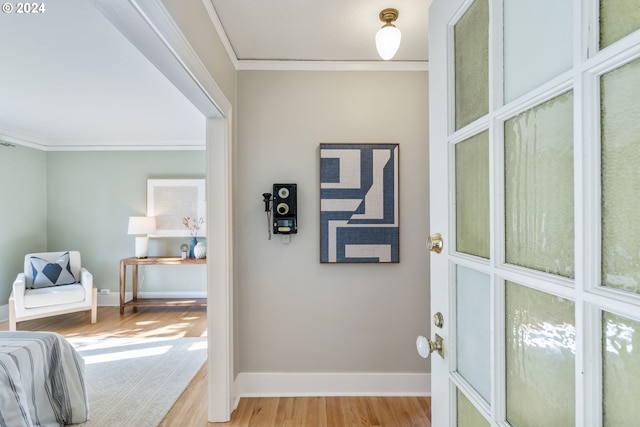 interior space with light hardwood / wood-style flooring and crown molding