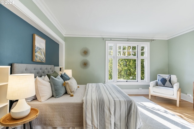 bedroom featuring ornamental molding and wood-type flooring