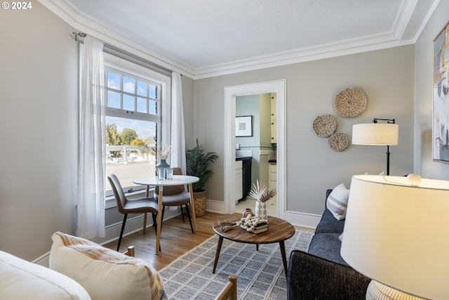 living area featuring ornamental molding and hardwood / wood-style floors