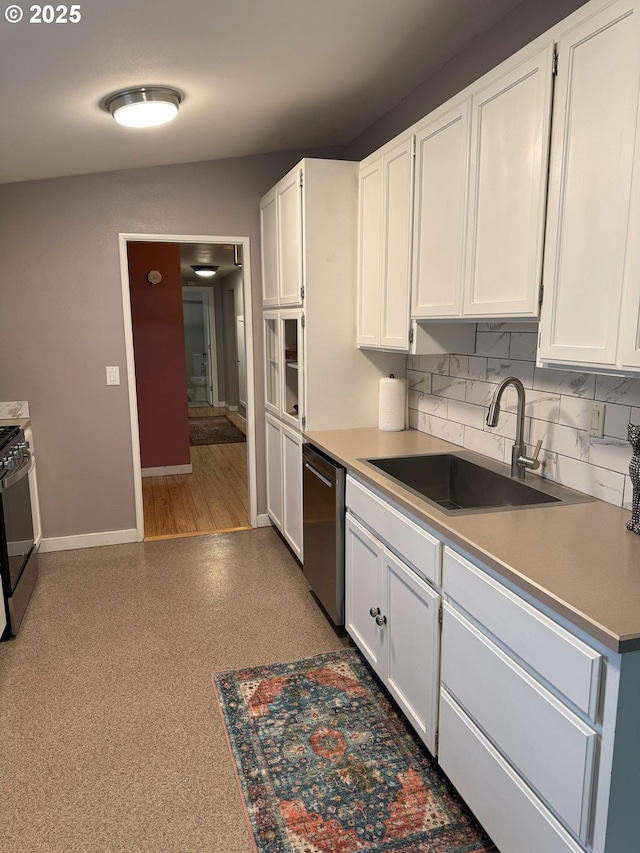 kitchen with stainless steel appliances, white cabinets, decorative backsplash, and sink