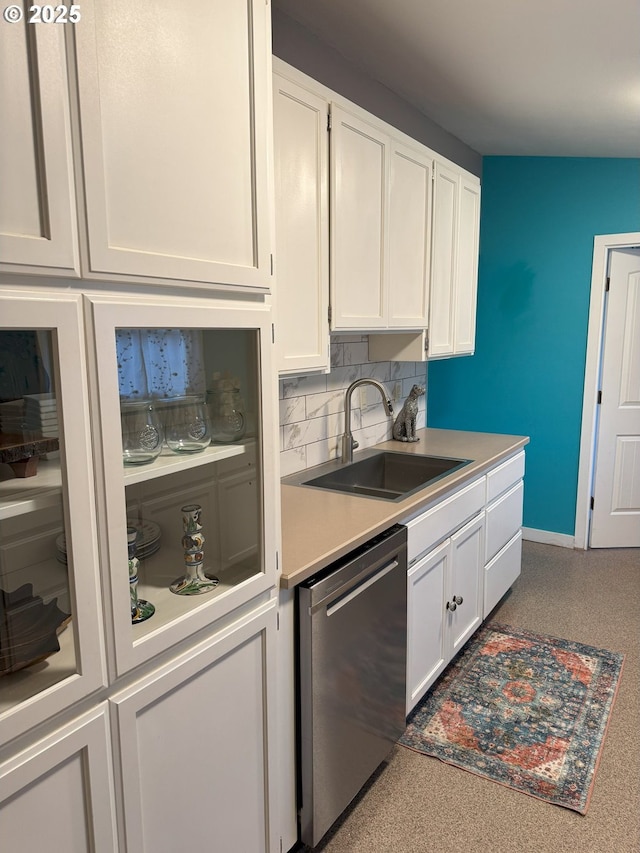 kitchen with sink, white cabinetry, dishwasher, and tasteful backsplash