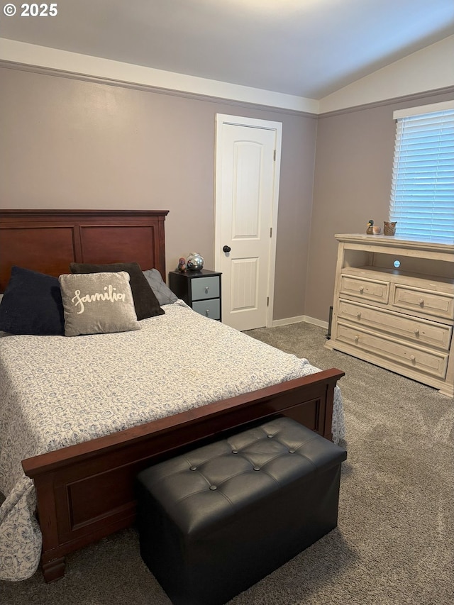 carpeted bedroom with lofted ceiling