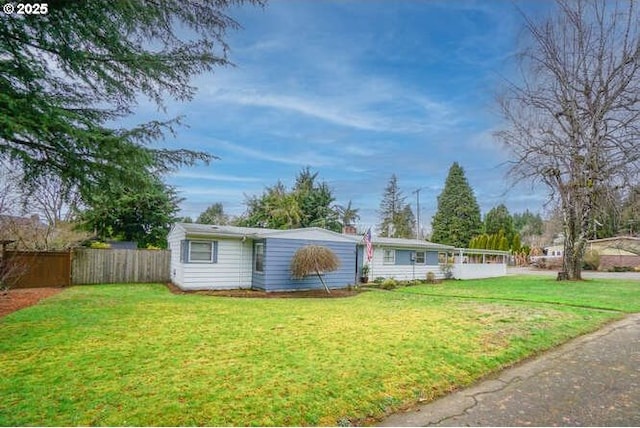 view of front of house featuring fence and a front yard