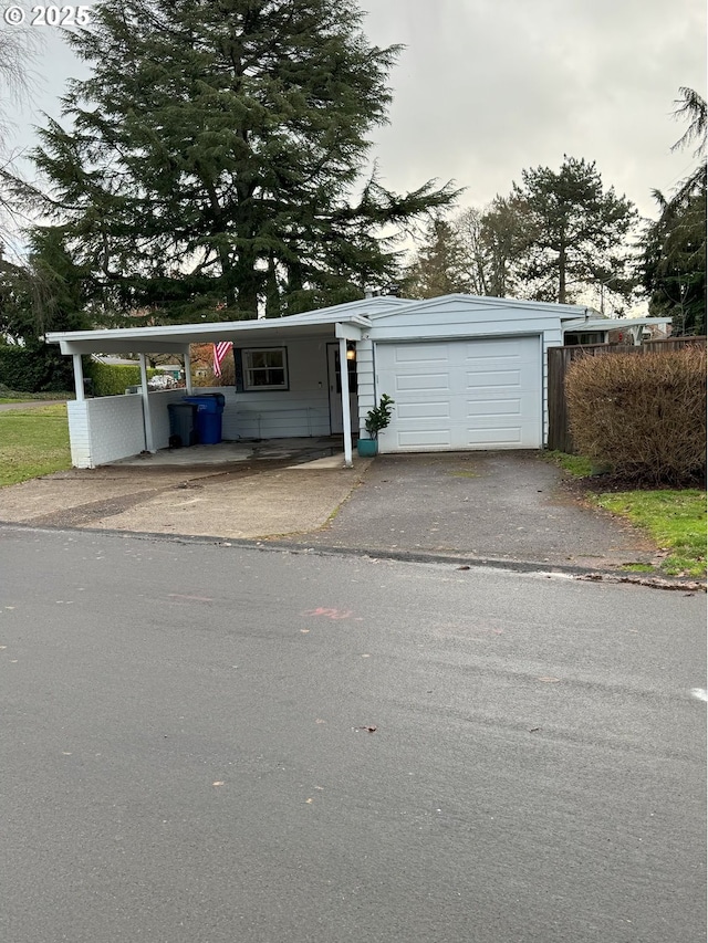 view of front of property with a carport and a garage