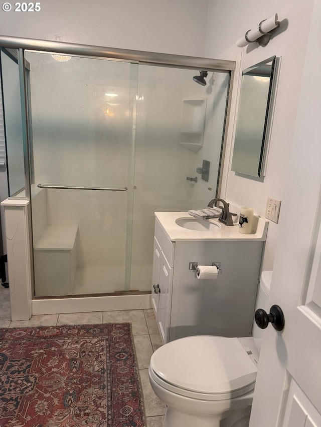 bathroom featuring walk in shower, tile patterned flooring, vanity, and toilet