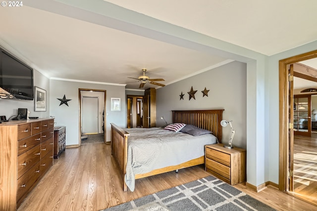 bedroom with ceiling fan, light hardwood / wood-style floors, and ornamental molding