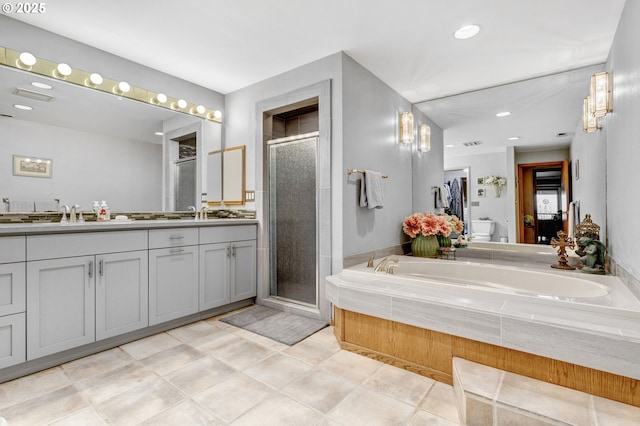 bathroom featuring vanity, tile patterned floors, and plus walk in shower