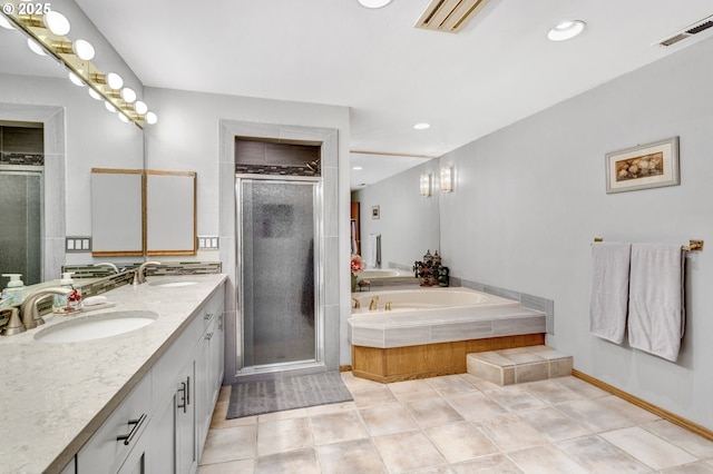 bathroom featuring vanity, tile patterned floors, and plus walk in shower