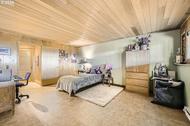 carpeted bedroom featuring baseboard heating, wood walls, and wooden ceiling