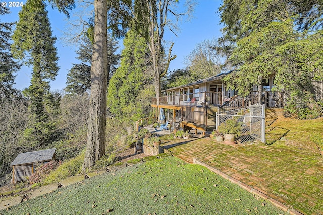 view of yard featuring a deck and a patio area