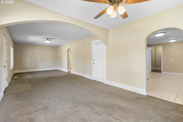 213 Engle Ave, Molalla, OR 97038 - empty room featuring ceiling fan, carpet flooring, arched walkways, crown molding, and tile patterned floors