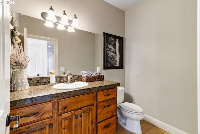 bathroom with vanity, tile patterned flooring, toilet, and backsplash