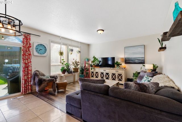 living room with an inviting chandelier and wood-type flooring