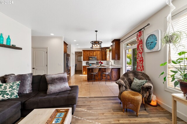 living room featuring sink and light wood-type flooring