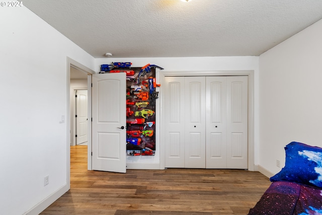 bedroom featuring a textured ceiling and dark wood-type flooring