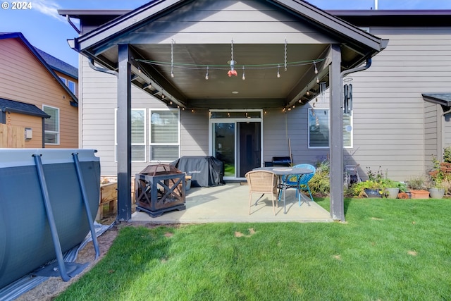 back of property with a patio and a yard