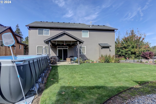 back of property featuring a yard and a patio