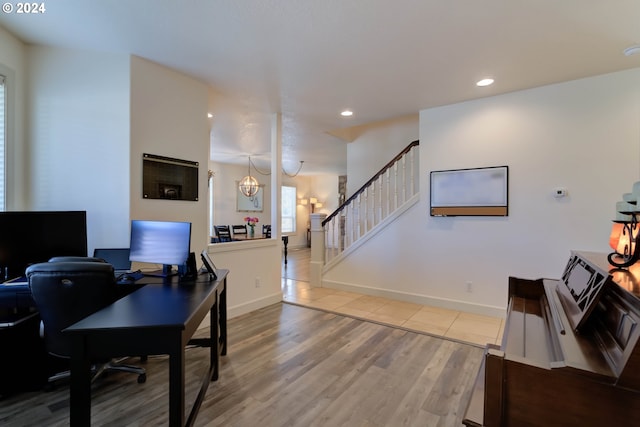 office area with light wood-type flooring and a chandelier