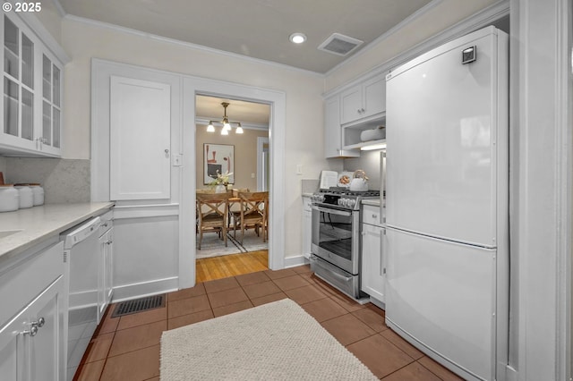 kitchen with tile patterned flooring, white appliances, and visible vents