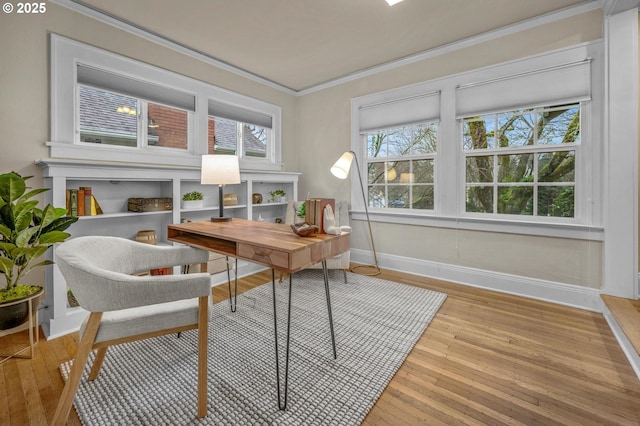 office area featuring ornamental molding, hardwood / wood-style floors, and baseboards