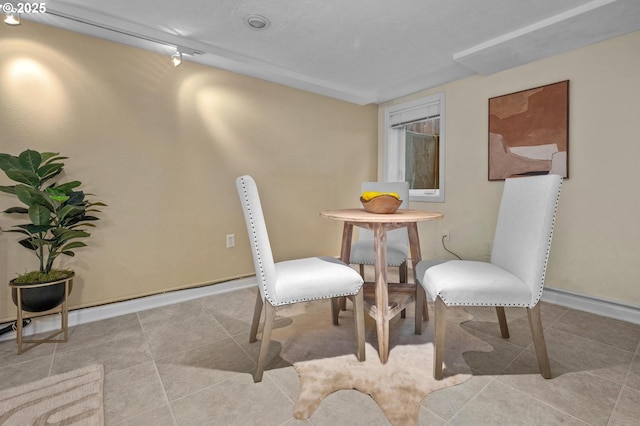 dining area featuring tile patterned flooring and baseboards