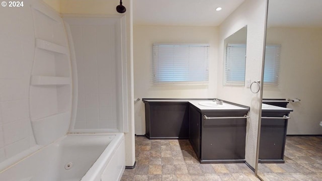 bathroom with vanity and a tub