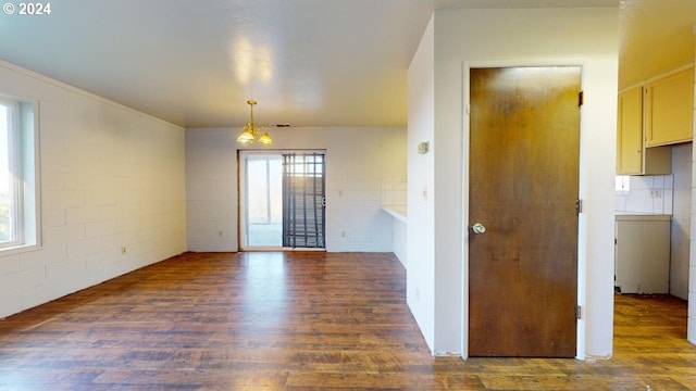 unfurnished room with dark hardwood / wood-style flooring and an inviting chandelier