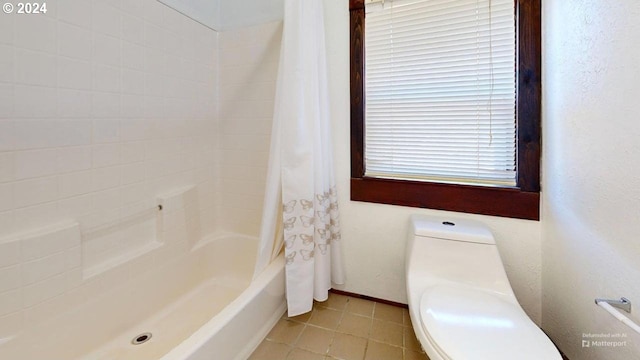 bathroom featuring toilet and shower / bathtub combination with curtain