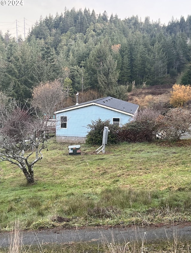 view of side of property with a yard